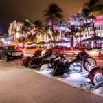 Motorcycles parked on Ocean Drive at night, showcasing the vibrant nightlife.