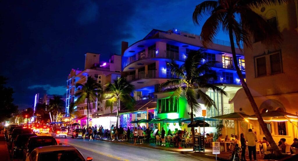 Ocean Drive illuminated by its iconic neon lights at night.