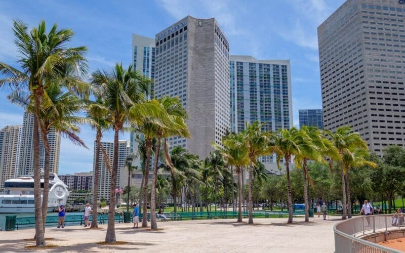 A sunny afternoon at Bayfront Park with a group of Downtown Miami buildings against the sky.