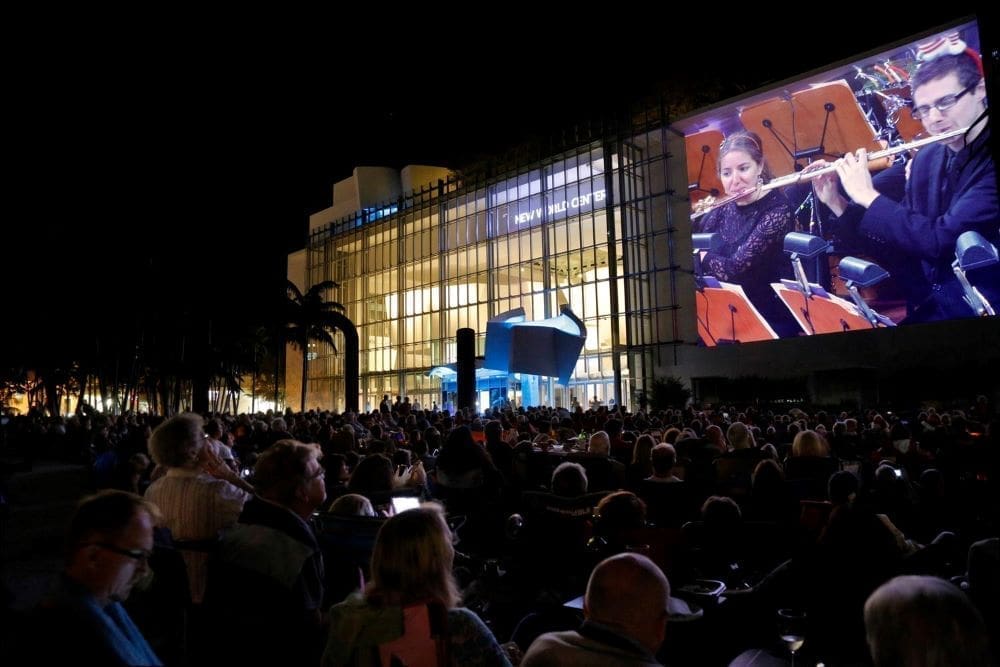 A nighttime open-air concert takes place at Soundscape Park, just in front of the New World Center.