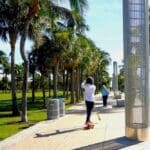 Young men skate along the South Pointe Park promenade