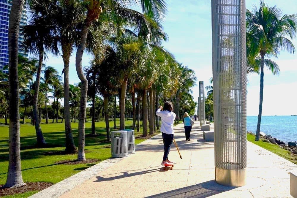 Young men skate along the South Pointe Park promenade