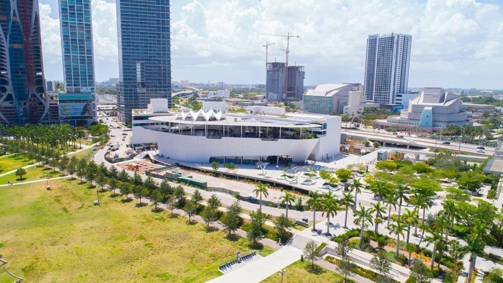 A bird's eye view of the Phillip & Patricia Frost Museum of Science with towering skyscrapers in the background.