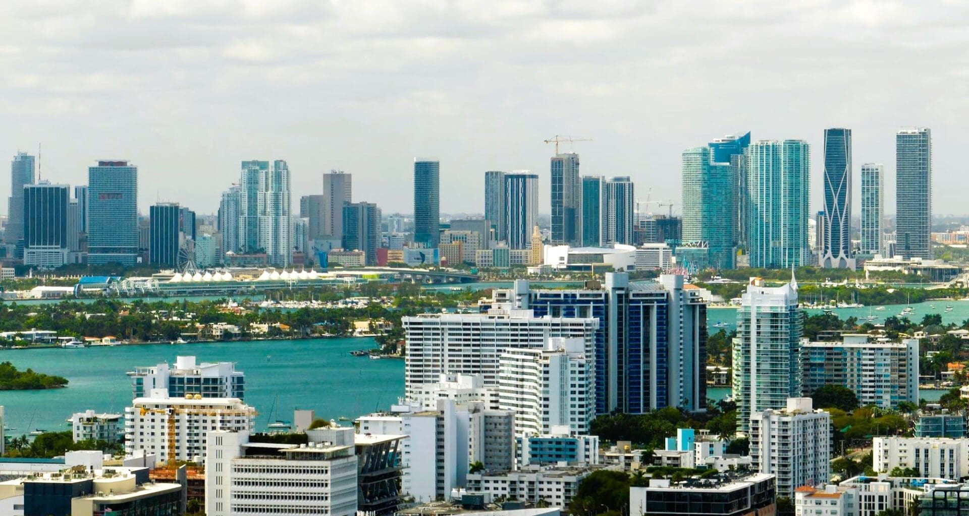 Aerial view of Miami's downtown office district on a bright, sunny day, showcasing towering commercial and residential skyscrapers