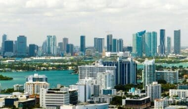 Aerial view of Miami's downtown office district on a bright, sunny day, showcasing towering commercial and residential skyscrapers