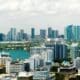 Aerial view of Miami's downtown office district on a bright, sunny day, showcasing towering commercial and residential skyscrapers