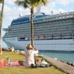 Pair observing a cruise ship set sail