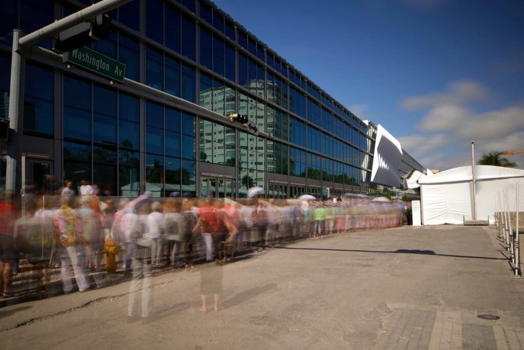 Long exposure shot capturing the motion of people lined up to enter Art Basel at the Miami Beach Convention Center