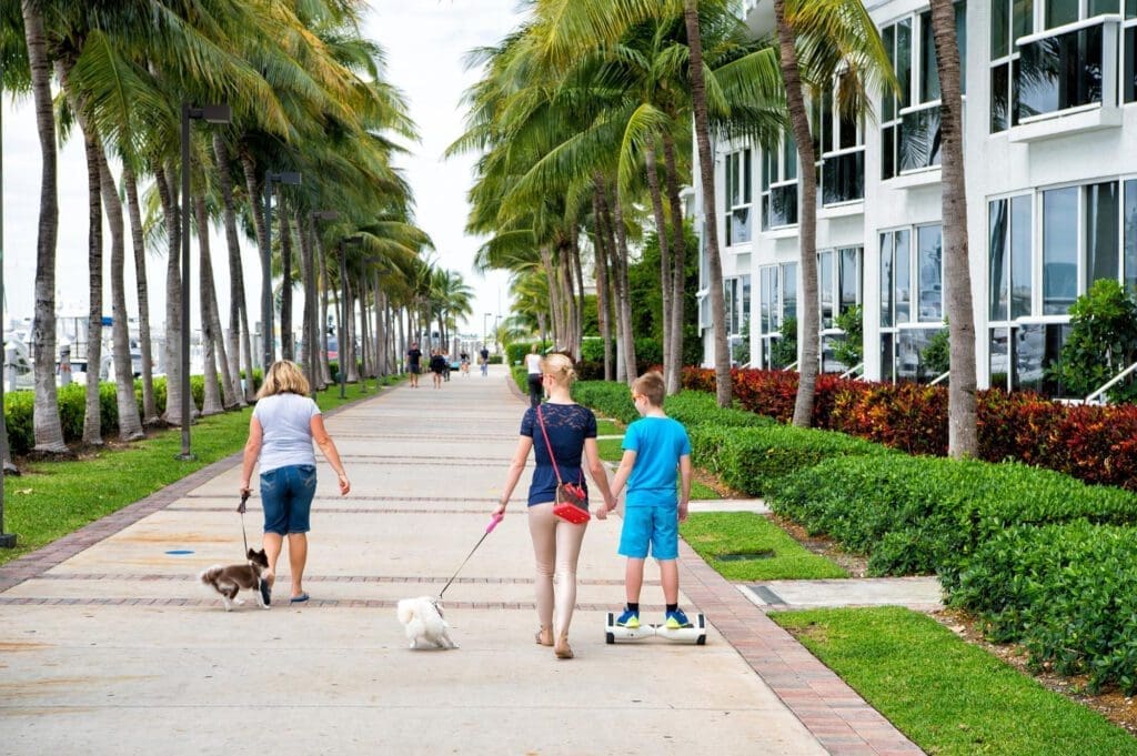 People strolling along the road in the picturesque South of Fifth area by the Miami Beach Marina