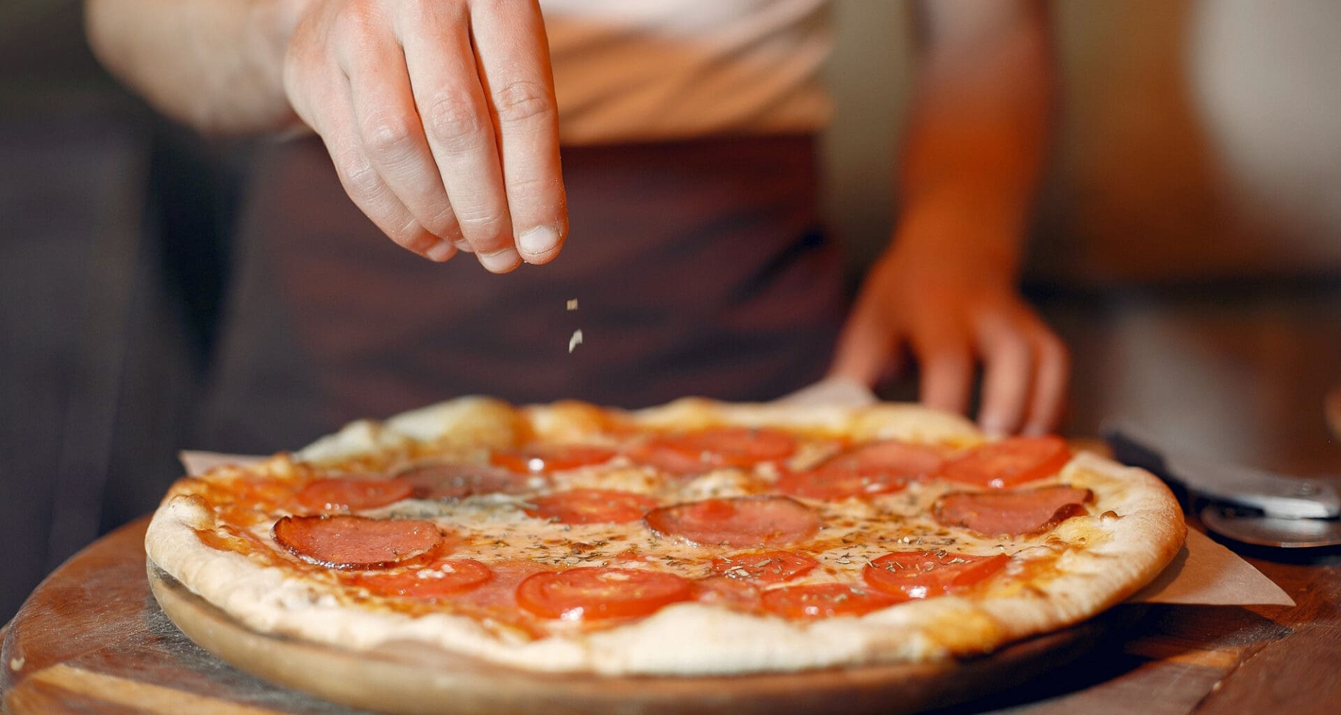 The chef at Lucali prepares a pizza