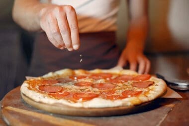 The chef at Lucali prepares a pizza
