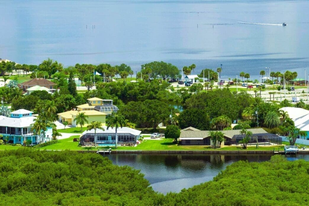 Aerial view of rural private houses in remote suburbs located near Florida wildlife wetlands
