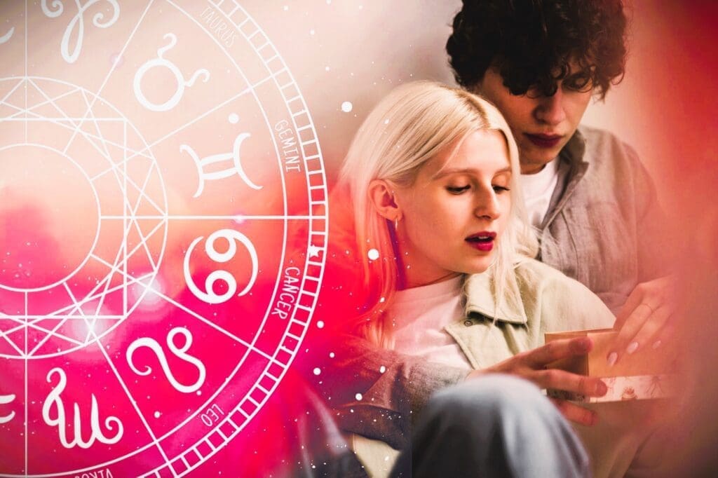 A couple sharing an embrace in front of an illustration of the zodiac wheel.