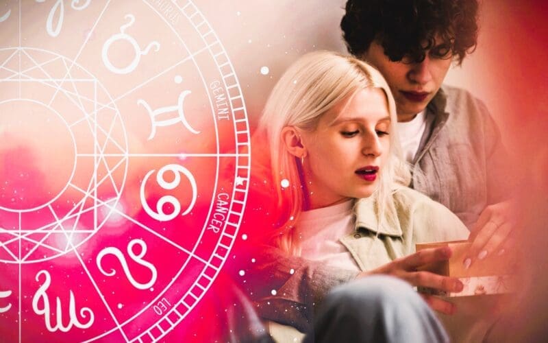 A couple sharing an embrace in front of an illustration of the zodiac wheel.