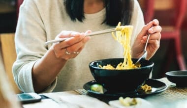 Close-up of an Asian woman eating noodles