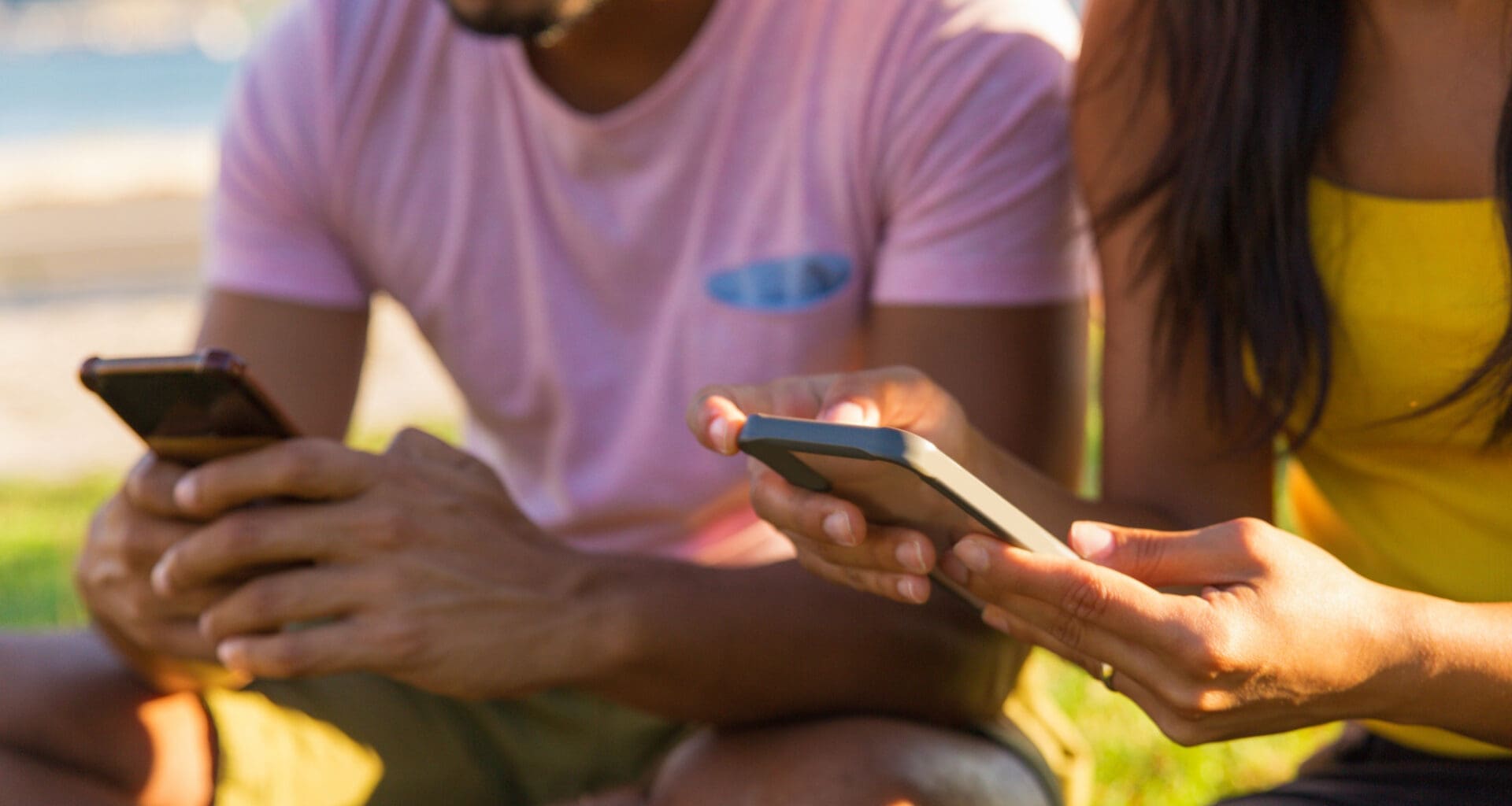 People using their mobile devices in the park