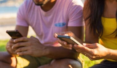 People using their mobile devices in the park