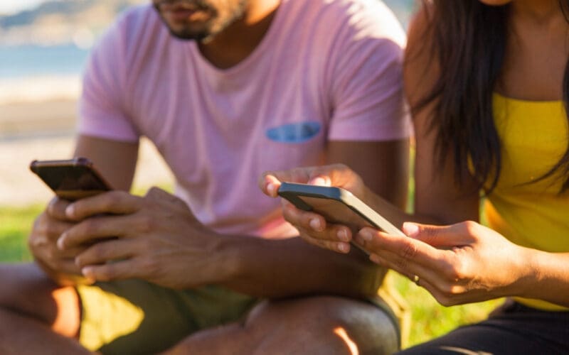 People using their mobile devices in the park