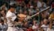 Professional MLB baseball player taking the swing in the middle of a cheering crowd