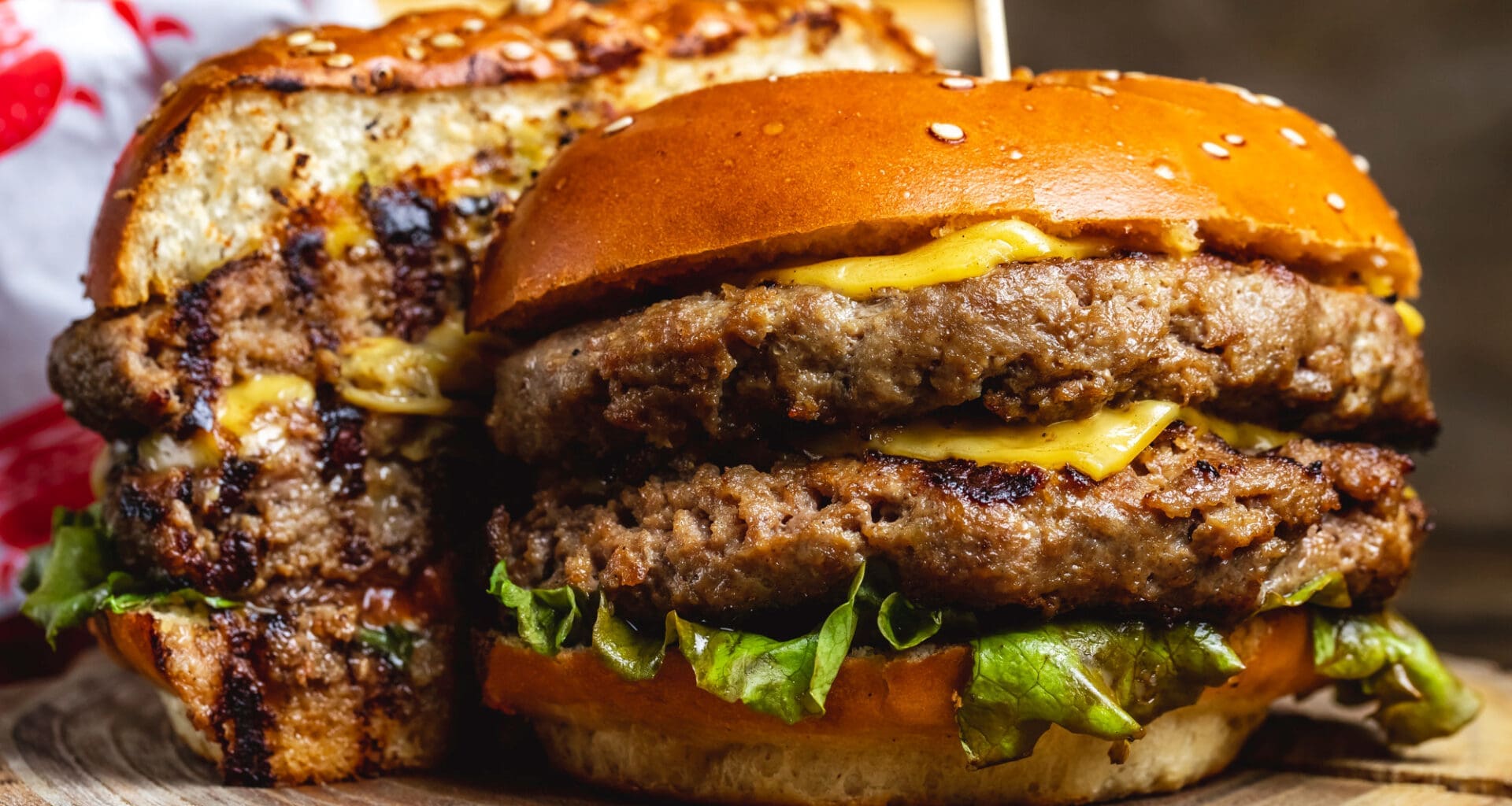 Side view of a double cheeseburger with beef patties, cheese, and lettuce