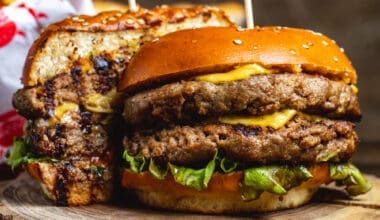 Side view of a double cheeseburger with beef patties, cheese, and lettuce