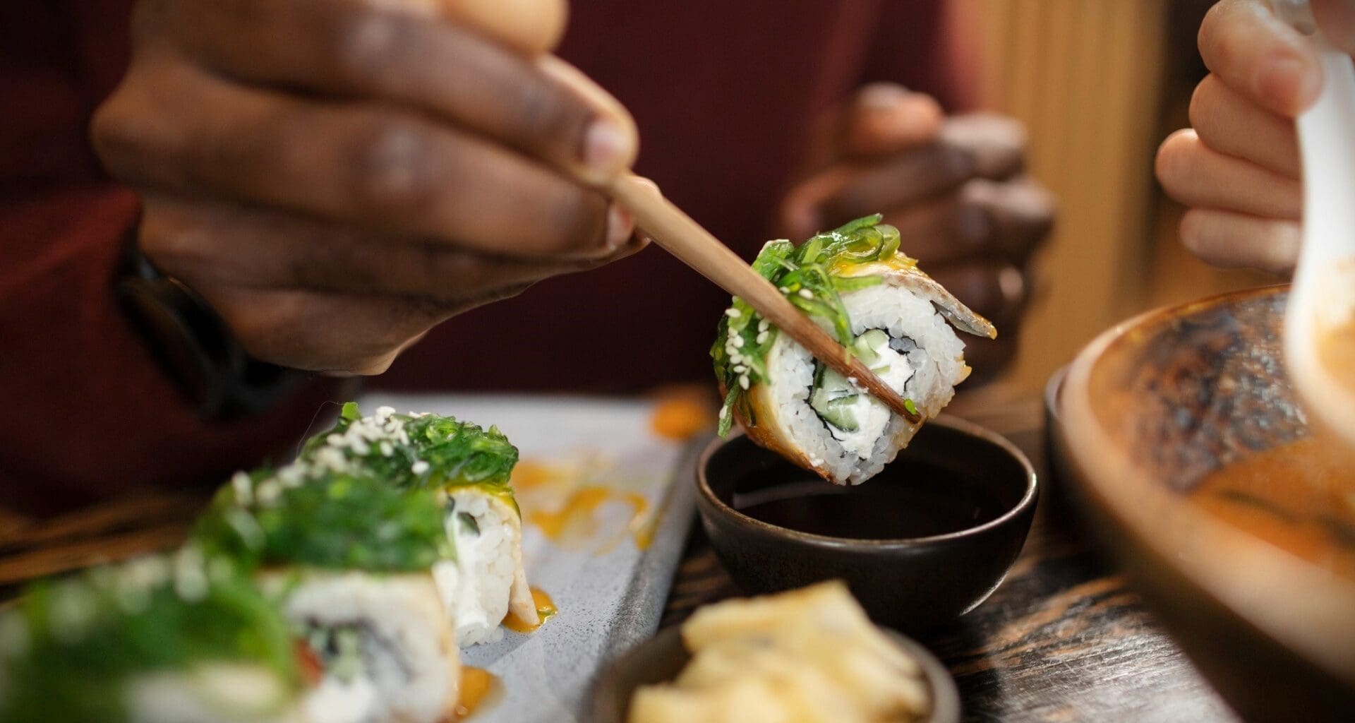 Someone savoring Japanese cuisine at a restaurant in Kyoto