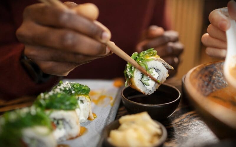 Someone savoring Japanese cuisine at a restaurant in Kyoto