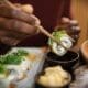 Someone savoring Japanese cuisine at a restaurant in Kyoto