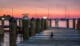 Sunset view of a boat dock with a duck