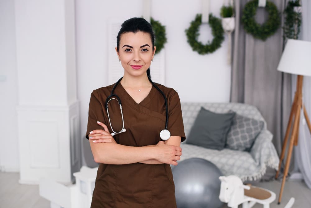 Smiling friendly children's doctor woman with stethoscope wearing brown medical robe health care medical concept