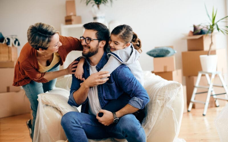 A joyful family chatting and enjoying themselves as they move into a new home