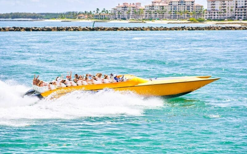 A thrilling speedboat ride through the vibrant blue waters of Miami, offering an exhilarating sense of adventure