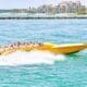 A thrilling speedboat ride through the vibrant blue waters of Miami, offering an exhilarating sense of adventure