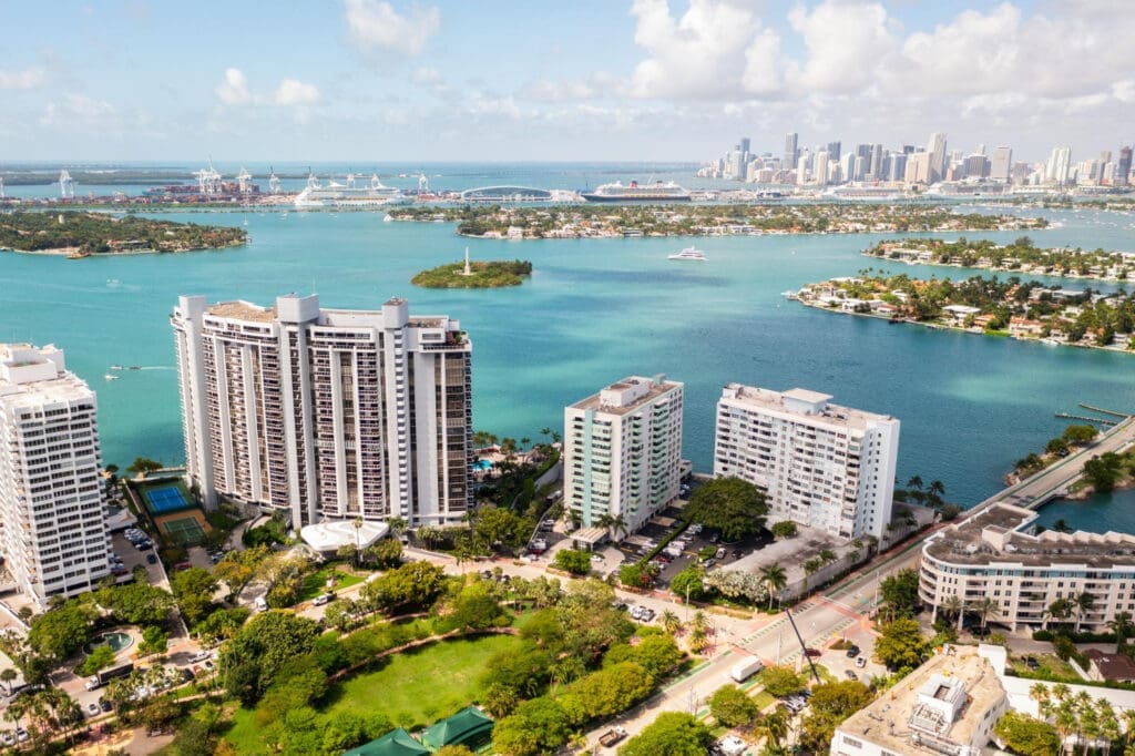 Aerial perspective showcasing the islands adjacent to Miami Beach, Biscayne Bay, the Port of Miami, with the Miami skyline beautifully framed in the background