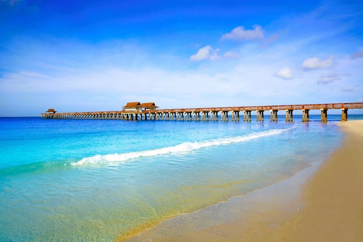 Breathtaking vista of Naples Pier and the shoreline, adorned with its shimmering turquoise waters