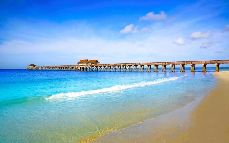 Breathtaking vista of Naples Pier and the shoreline, adorned with its shimmering turquoise waters