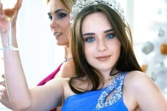Cheerful young girls posing with glasses of wine at the lively celebration