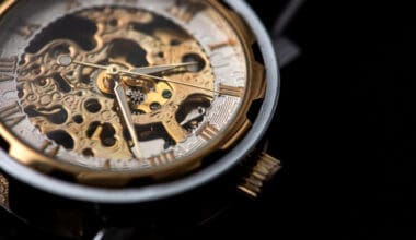 Close-up of a luxurious gold clock displaying a time adjustment