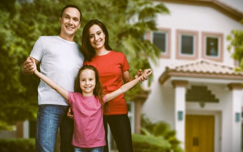 Happy Family Portrait with Their Daughter After Purchasing a New Home