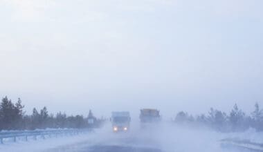 Highway featuring trucks navigating through severe winter weather