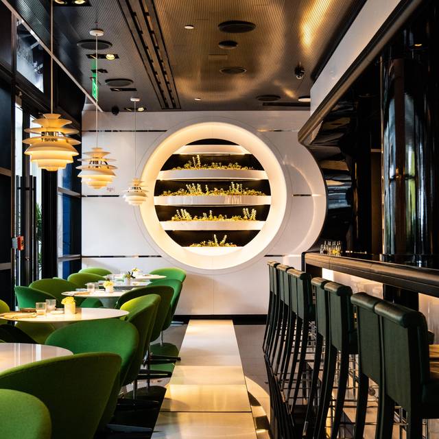 A beautifully plated, vibrant dish from Le Jardinier restaurant in Miami's Design District, showcasing fresh, plant-focused ingredients in an elegant dining setting.