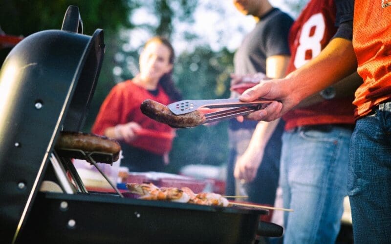 People getting ready to cook on a barbecue grill