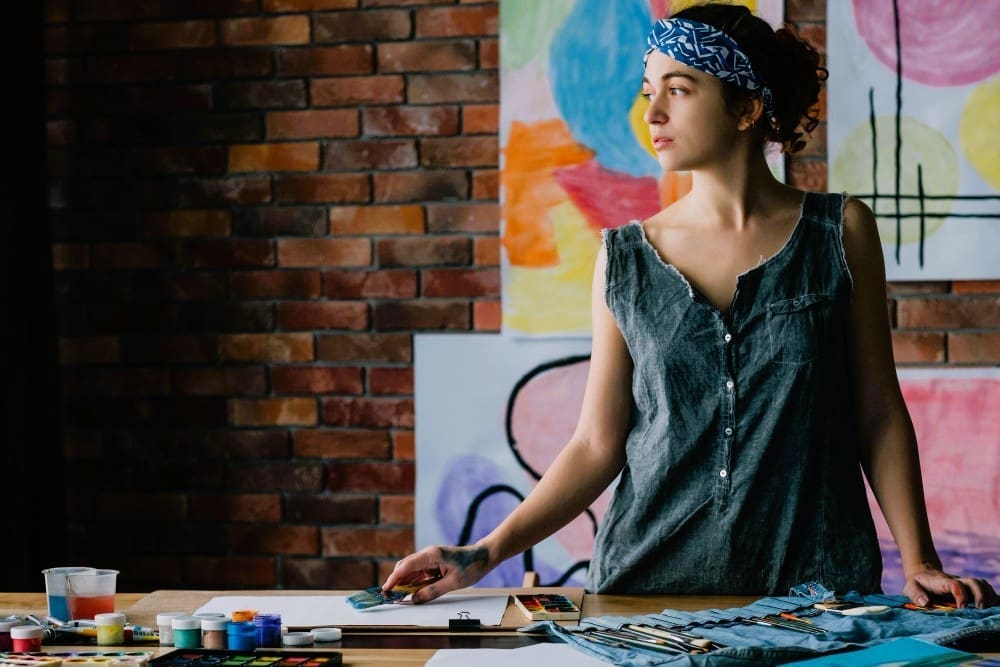 Portrait of a contemplative female painter in her art studio, embodying creativity and inspiration