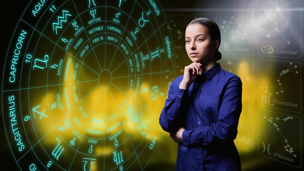 Portrait of a young professional woman with a background featuring astrological horoscope signs