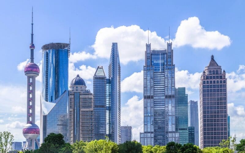 The iconic Oriental Pearl TV Tower stands tall amidst Shanghai's skyline, surrounded by the vibrant energy of the city's financial district