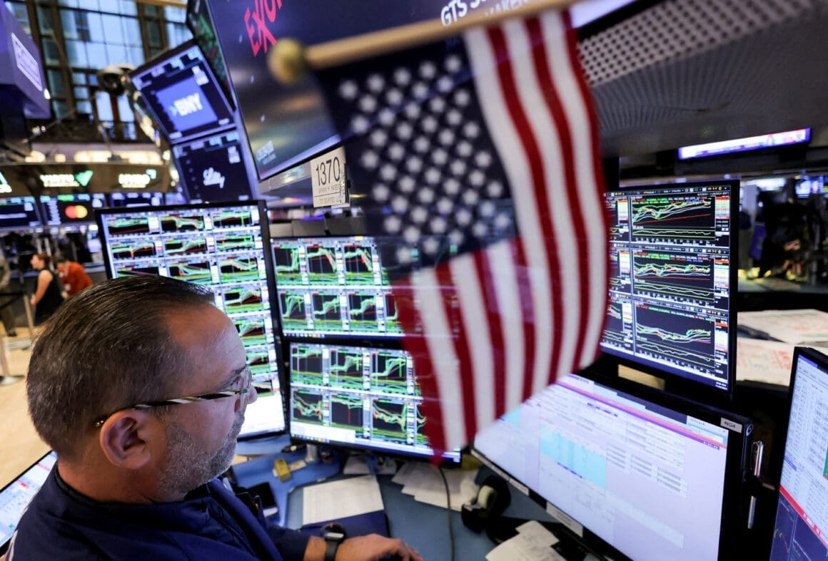 Traders work on the floor at the New York Stock Exchange (NYSE)
