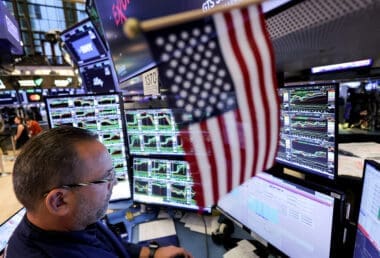 Traders work on the floor at the New York Stock Exchange (NYSE)