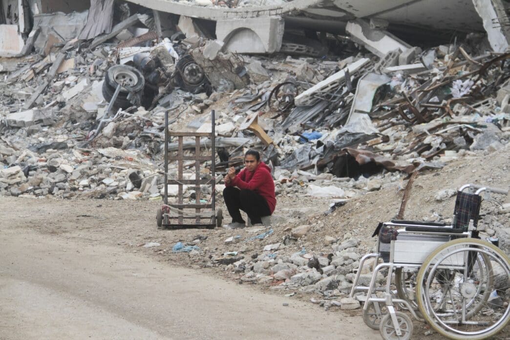 A Palestinian girl sits by the rubble of buildings destroyed in previous Israeli strikes, ahead of a ceasefire set to take effect on Sunday, in Gaza City