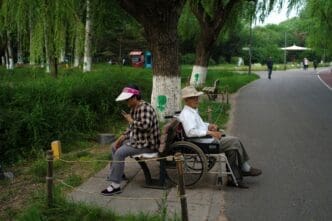 Elderly people rest at a park on a summer day in Beijing