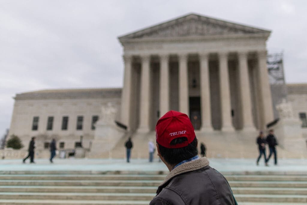 A supporter of U.S. President-elect Donald Trump stands outside the U.S. Supreme Court, in Washington